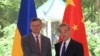 Menteri Luar Negeri Ukraina Dmytro Kuleba (kiri), berfoto bersama Menteri Luar Negeri China Wang Yi sebelum pertemuan di kota Guangzhou, China selatan, Rabu, 24 Juli 2024. (Lu Hanxin/Xinhua via AP)