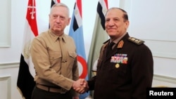 FILE - Egypt's Chief of Staff of the Armed Forces Sami Anan, right, shakes hands with the U.S. Commander of the Central Command James Mattis during a meeting in Cairo, Egypt, March 29, 2011. Anan announced his candidacy for president of Egypt on Saturday.