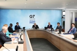 FILE - G-7 summit participants are seen during a session in Cornwall, England, June 12, 2021.
