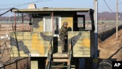 FILE - A South Korean army soldier stands guard at a military guard post in Paju, South Korea, near the border with North Korea, Dec. 25, 2017. The day before, North Korea called the most recent U.N. sanctions to target the country "an act of war" that violated its sovereignty.