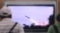 FILE - People watch a TV news program showing the missile launch conducted by North Korea, at Seoul Railway Station in Seoul, South Korea, June 29, 2014. 