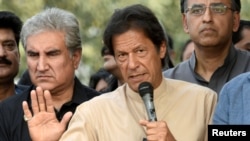 FILE - Pakistani opposition leader Imran Khan talks to the media outside his house in Islamabad, Pakistan, November 1, 2016. Speaking Friday on future Pakistan-Afghanistan relations, Khan said he sees “open borders” and “free trade” between the two countries.