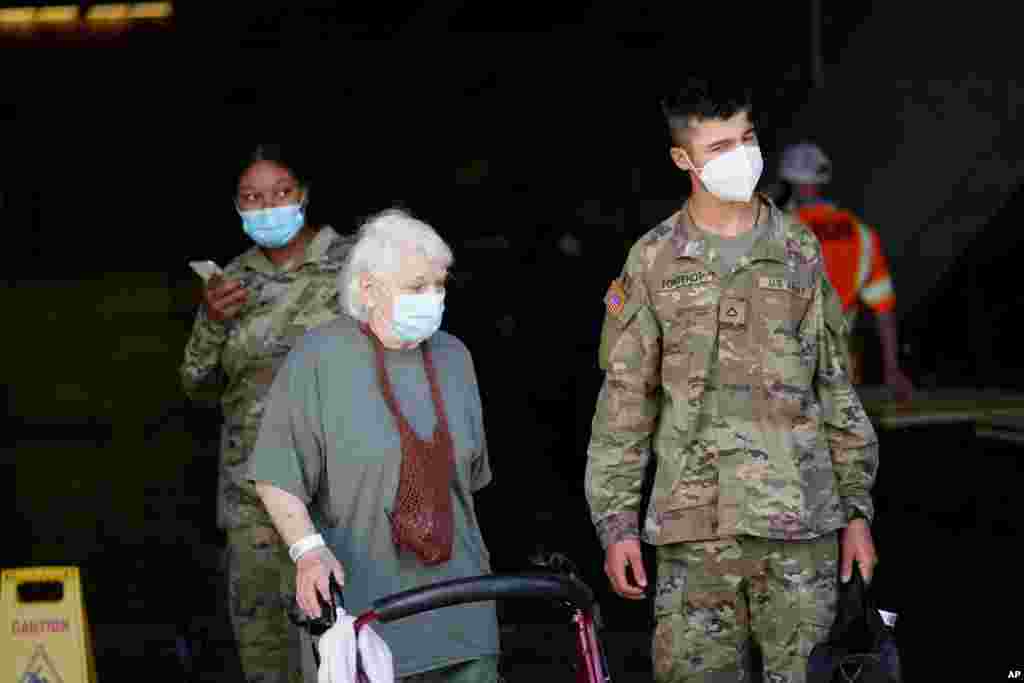Yvonne Lancgo, of Lake Charles, waits to board a bus to evacuate Lake Charles, La., Aug. 26, 2020, ahead of Hurricane Laura. 
