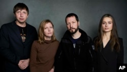 FILE - From left, photographer Evgeniy Maloletka, "Frontline" producer Michelle Mizner, director Mstyslav Chernov and field producer Vasilisa Stepanenko pose for a portrait to promote "20 Days in Mariupol" during the Sundance Film Festival on Jan. 22, 2023, in Park City, Utah.