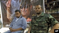 Motasin Younis, left, and Mohammed Hamed Younis, right, son and nepheiw of Libyan rebels' slain military chief Abdel-Fattah Younis seen during a interview in rebel-held Benghazi, Libya, Aug. 1, 2011