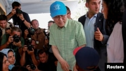 U.N. Secretary-General Ban Ki-moon greets a child during his visit at the municipality-run refugee camp of Kara Tepe on the island of Lesbos, Greece, June 18, 2016.