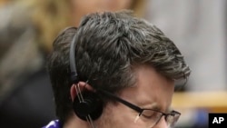 An MEP's wearing a scarf reacts after a vote on the UK's withdrawal from the EU, the final legislative step in the Brexit proceedings, during the plenary session at the European Parliament in Brussels, Jan. 29, 2020.