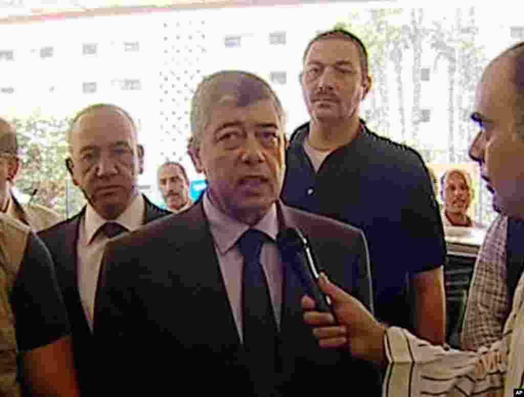 In this image from Egyptian State Television, Egyptian Interior Minister Mohamed Ibrahim responds to a reporter after an explosion near his convoy in Cairo, Sept. 5, 2013.