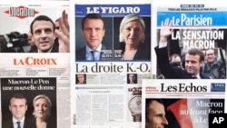 French newspaper front pages report the winners of the first round of the French presidential election, centrist candidate Emmanuel Macron and far-right candidate Marine Le Pen, April 24, 2017. 