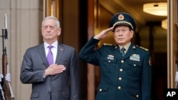 U.S. Defense Secretary Jim Mattis and Chinese Minister of Defense Gen. Wei Fenghe stand as the national anthems are played during a welcome ceremony at the Pentagon, Nov. 9, 2018.