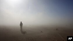 A Sahrawi man stands in the Sahara desert between Tindouf and Tifariti, February 26, 2011.