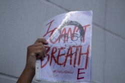 An activist holds up a picture of missing Thai dissident Wanchalearm Satsaksit during a rally in front of the Cambodian Embassy in Bangkok on June 8, 2020.