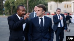 Ethiopia's Prime Minister Abiy Ahmed, left, speaks with France's President Emmanuel Macron during a visit at the newly renovated Ethiopia's historic National Palace in Addis Ababa on Dec. 21, 2024.