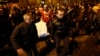 Anti-government protesters carry a dead body covered with a sheet during the transfer of over a dozen of corpses from a hotel lobby to a local hospital following clashes with riot police at Independence Square in Kyiv Feb. 20, 2014.