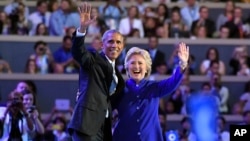 President Barack Obama and Democratic Presidential candidate Hillary Clinton wave together during the third day of the Democratic National Convention in Philadelphia , July 27, 2016. 