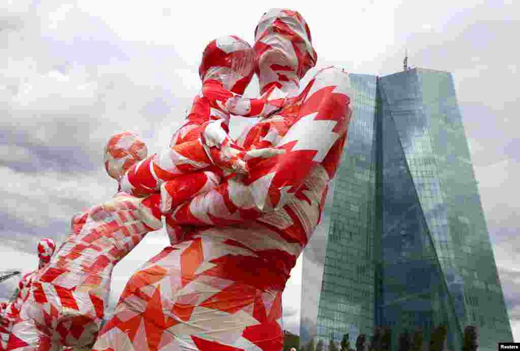 A partially incomplete display of mannequins wrapped in a barrier tape to symbolize the coronavirus disease (COVID-19) crisis, as part of the art installation "It is like it is" by German art student Dennis Josef Meseg, is seen in front of the European Central Bank headquarters in Frankfurt, Germany.