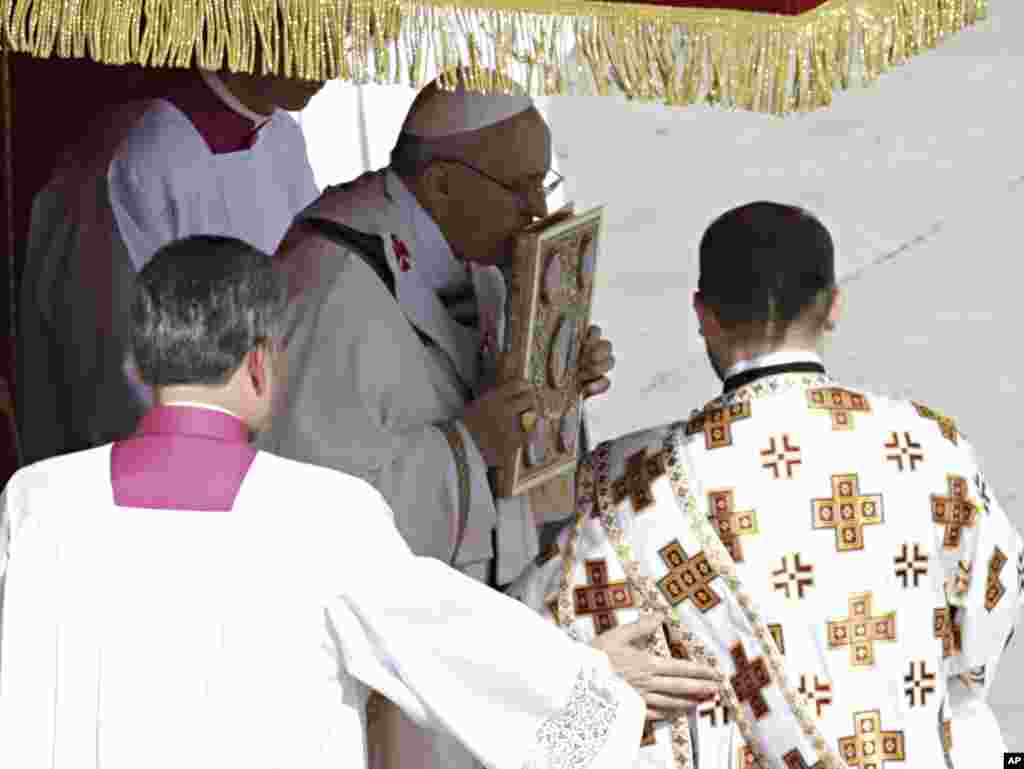Pope Francis receives the ring symbolizing the papacy and a wool stole symbolizing his role as shepherd of his 1.2-billion strong flock, March 19, 2013.