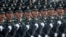 FILE - Soldiers of People's Liberation Army march in formation during the military parade marking the 70th founding anniversary of People's Republic of China, on its National Day in Beijing, Oct. 1, 2019.