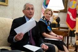 FILE - White House coronavirus response coordinator Dr. Deborah Birx listens as Director of the National Institute of Allergy and Infectious Diseases Dr. Anthony Fauci, left, speaks at the White House, April 29, 2020, in Washington.