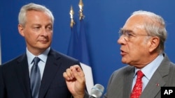 French Finance Minister Bruno Le Maire, left, attends a joint press conference with OECD chief Angel Gurria to plan for international taxes on digital giants like Amazon and Google at Bercy Economy ministry in Paris, Thursday, Aug. 29, 2019. 