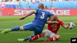 Un geste anti-sportif de Martin Skrtel de la Slovaquie, à gauche, à l’endroit de Jonathan Williams de Pays de Galles lors du match de football du Groupe B au cours de l’Euro 2016 entre pays de Galles et la Slovaquie, au Nouveau stade à Bordeaux, France, 