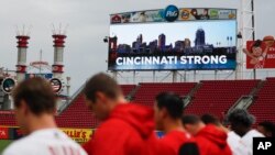 A moment of silence is observed for the dead and wound in a shooting downtown, at Great American Ball Park before a baseball game between the Cincinnati Reds and the San Diego Padres, Sept. 6, 2018, in Cincinnati.