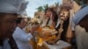 FILE - Balinese Hindu prepare for a procession during a Melasti purification ceremony ahead of the holy day of Nyepi, on Purnama Beach, Gianyar, Bali, Indonesia March 14, 2018 in this photo taken by Antara Foto. 