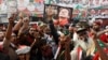 People chant slogans as they condemn the shooting incident on a long march held by Pakistan's former Prime Minister Imran Khan, in Wazirabad, Pakistan, Nov. 4, 2022. 