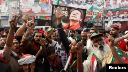 People chant slogans as they condemn the shooting incident on a long march held by Pakistan's former Prime Minister Imran Khan, in Wazirabad, Pakistan, Nov. 4, 2022. 