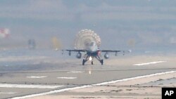 FILE - Turkish Air Force fighter planes land at Incirlik Air Base, on the outskirts of the city of Adana, southern Turkey.