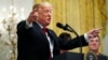 FILE - President Donald Trump gestures as he speaks about taxes, June 29, 2018, during an event in the East Room of the White House in Washington.
