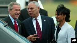 FILE - Former President George W. Bush arrives at Shannon Airport in western Ireland with Colin Powell, who was then his secretary of state, and Condoleeza Rice, who was his national security adviser, June 25, 2004.