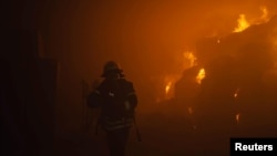 A firefighter works at a site of a tobacco factory damaged during Russian drone strike, amid Russia's attack on Ukraine, in Kyiv, Ukraine May 28, 2023. Pavlo Petrov/Press service of the State Emergency Service of Ukraine/Handout via REUTERS
