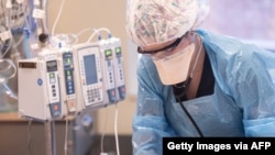 A health care worker tends to a patient on a ventilator in the Intensive Care Unit of Baptist Health Floyd on Sept. 7, 2021 in New Albany, Indiana. 