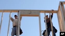 FILE -Construction workers in Orlando, Fla.