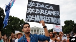 Carlos Esteban, 31, of Woodbridge, Va., a nursing student and recipient of Deferred Action for Childhood Arrivals, known as DACA, rallies with others in support of DACA outside of the White House, in Washington, Sept. 5, 2017. 