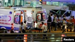FILE - Paramedics push a stretcher at Turkey's largest airport, Istanbul Ataturk, following a blast in Turkey, June 28, 2016. 