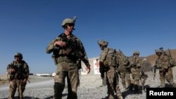 FILE - U.S. troops wait for their helicopter flight at an Afghan National Army (ANA) base in Logar province, Afghanistan, Aug. 7, 2018.