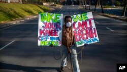 A man wearing chains joins a protest rally in front of the U.S. Consulate General in Johannesburg, South Africa, June 8, 2020, in response to the recent killing of George Floyd in Minneapolis, USA.