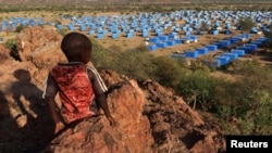 FILE - A boy looks over a refugee camp near the Chad-Sudan border, Nov. 9, 2023. Hundreds of Masalit families from Sudan's West Darfur state were sent here following a massacre in El Geneina. Sudan claims the UAE supplied arms to paramilitary forces in relation to the attacks.