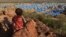 FILE - A boy looks over a refugee camp near the Chad-Sudan border, Nov. 9, 2023. Hundreds of Masalit families from Sudan's West Darfur state were sent here following a massacre in El Geneina. Sudan claims the UAE supplied arms to paramilitary forces in relation to the attacks.