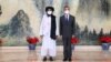 FILE - Chinese State Councilor and Foreign Minister Wang Yi, right, meets with Mullah Abdul Ghani Baradar, political chief of Afghanistan's Taliban, in Tianjin, July 28, 2021. (Photo released by China's Xinhua News Agency)