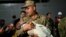 A soldier holds a baby as Turkish citizens evacuated from Lebanon disembark from the TCG Bayraktar war ship after its arrival at the southern Turkish port of Mersin on Oct. 10, 2024.