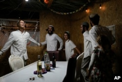 Israelis celebrate the news of the death of Hamas leader Yahya Sinwar, near Kibbutz Erez, southern Israel, on Oct. 17, 2024.