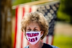 FILE - A supporter wears a face mask ahead of President Donald Trump's visit to an Owens and Minor warehouse in Allentown, Pa., May 14, 2020.