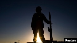 FILE - A member of the Afghan National Army stands guard in Nimroz province, southern Afghanistan, Jan. 9, 2010. (Reuters)