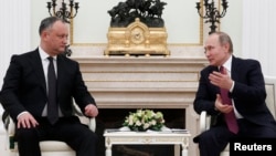 Russian President Vladimir Putin, right, meets with his Moldovan counterpart, Igor Dodon, at the Kremlin in Moscow, Jan. 17, 2017. 