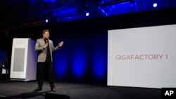FILE - Elon Musk, CEO of Tesla Motors, unveils the company’s Powerpack, in Hawthorne, California, April 30, 2015. A 53-megawatt hour battery station will soon be providing power for the Hawaiian island of Kauai. 