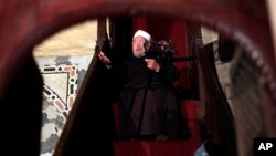 FILE - Shiekh Youssef al-Qaradawi, gives a sermon during Friday prayers at al-Azhar mosque in Cairo, Egypt.