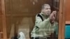 FILE - In this photo taken from video released by the Moscow City Court Press Service, Stephen Hubbard, a U.S. citizen accused of fighting as a mercenary in Ukraine, stands in a glass cage during a court session in the Moscow City Court on Oct. 7, 2024.